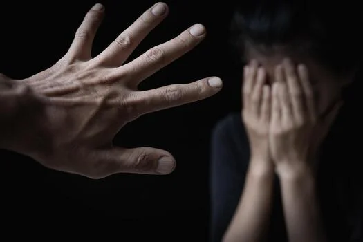 men-s-hands-will-hurt-women-women-bow-their-heads-and-cover-their-hands-concept-of-sexual-harassment-human-trafficking-family-rape-harassment-to-the-defenseless-international-women-s-day-photo